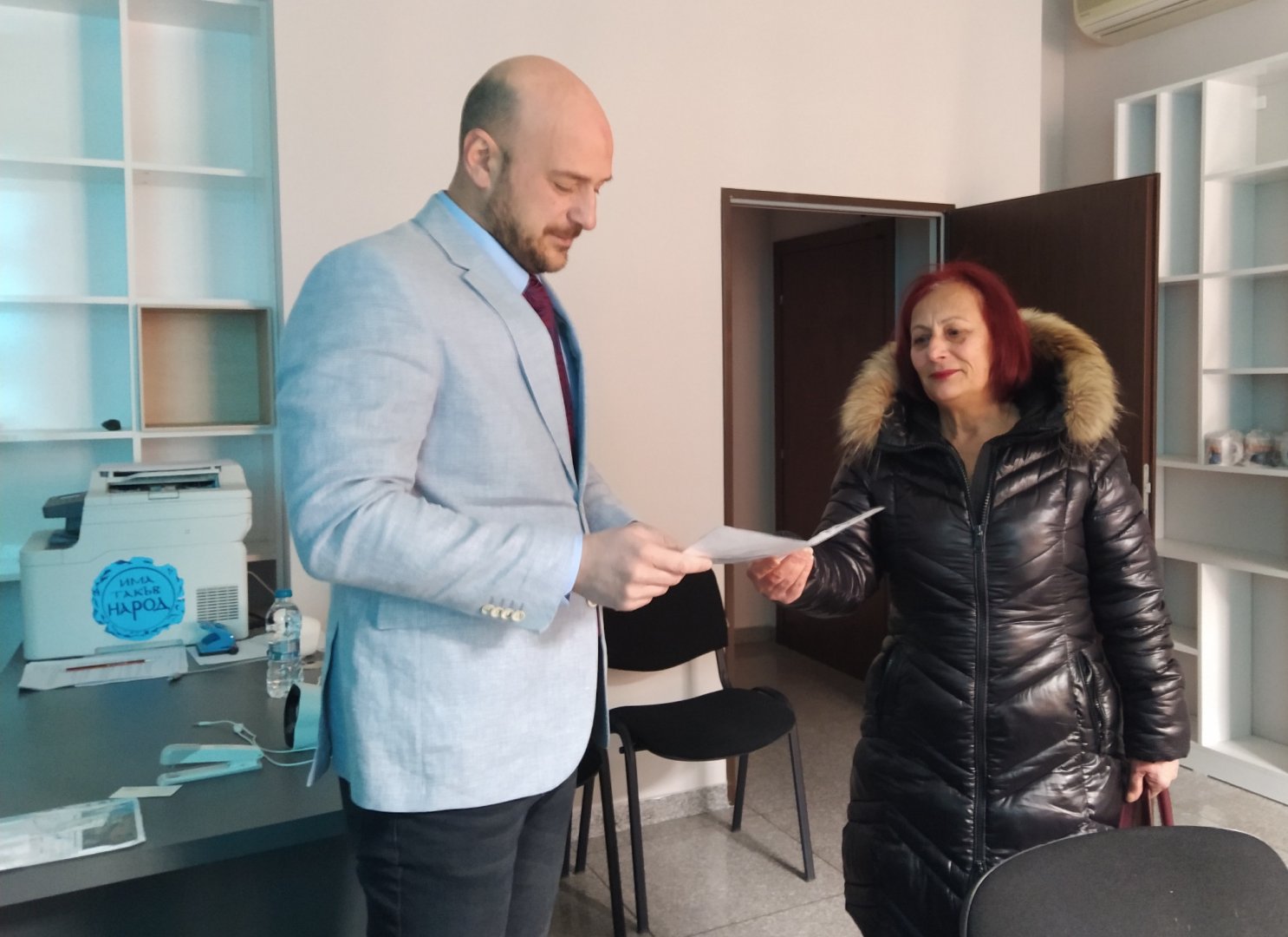 Бургазлийка предаде попълнена и подписана бланка за референдума на областния координатор на ИТН Тодор Иванов. Снимка Петя Добрева